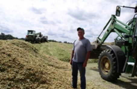 Man standing next to plow