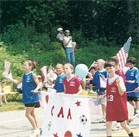Children holding a CAA sign on parade